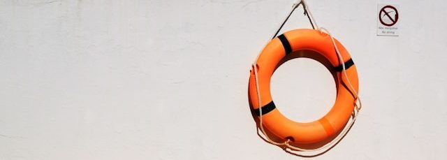Orange lifesaver hanging on a wall