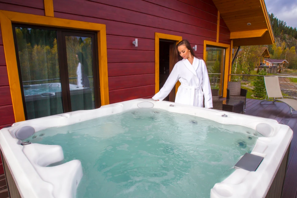 A woman about to enter a well maintained hot tub